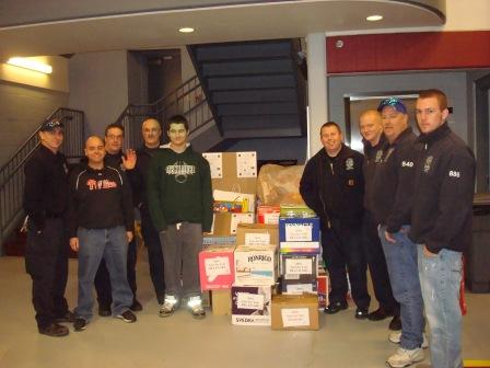 Toys for Tots receives 750 books at the Claymont Fire Station. Pictured is organizer Matt Mcneill with members of the fire station!