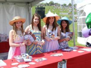 Success Won't Wait volunteers from H.B. duPont Middle School -- Claire Gonye, Shannon Martin, Christine McNeill and Alexandra Costantini show off some of the PONY USA books that were handed out at the annual Point-to-Point event.