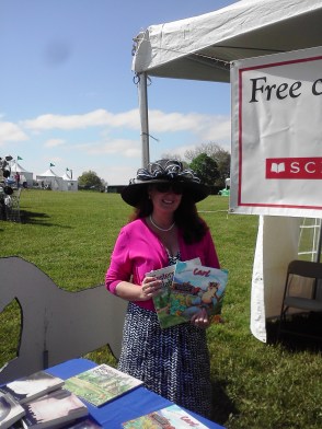 Success Won't Wait co-founder and Director Susan Conforte McNeill with just a few of the 500 children's books which were given away throughout the day.