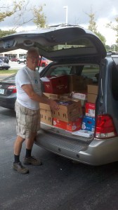 Larry Thurrell of the Friends of the Hockessin Library with some of the 800+ recently donated by Success Won't Wait!