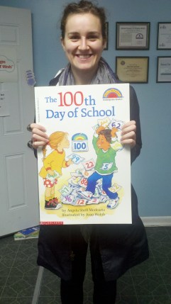 Showing off just one of the many books donated is Camden HeadStart representative Diana Husanu.