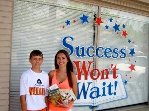 Pictured are Angela and David Preziuso, Success Won't Wait volunteers, with some of the almost 200 books they collected through their book drive.