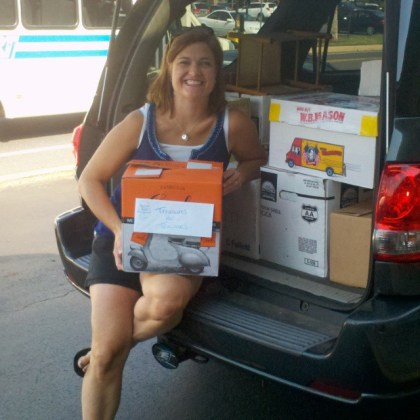 Cristen Zipf of Treasures for Educators with some of the more than 750 books donated by Success Won't Wait this week.