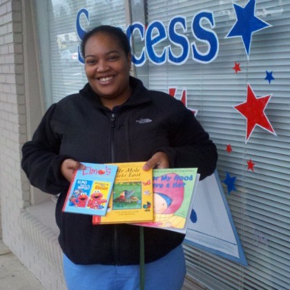 Shamiya Thompson of the Nemours Pediatric Clinic didn't let the cold weather deter her. Her she is, pictured with some of the 300+ children's books that Success Won't Wait donated to nemours' book giveaway program on this blustery January morning!