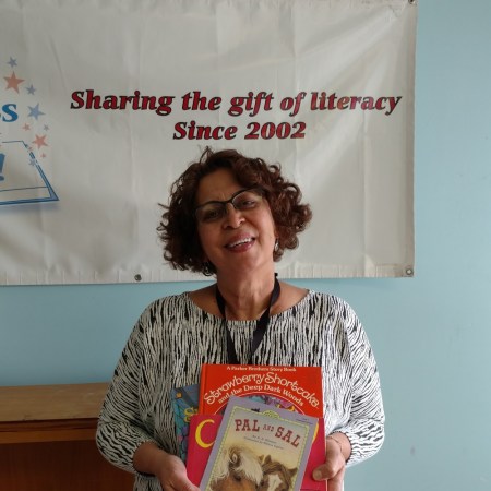 Neda Green of the Friends of the Wilmington Library with just a few of the 500 books provided by Success Won't Wait.