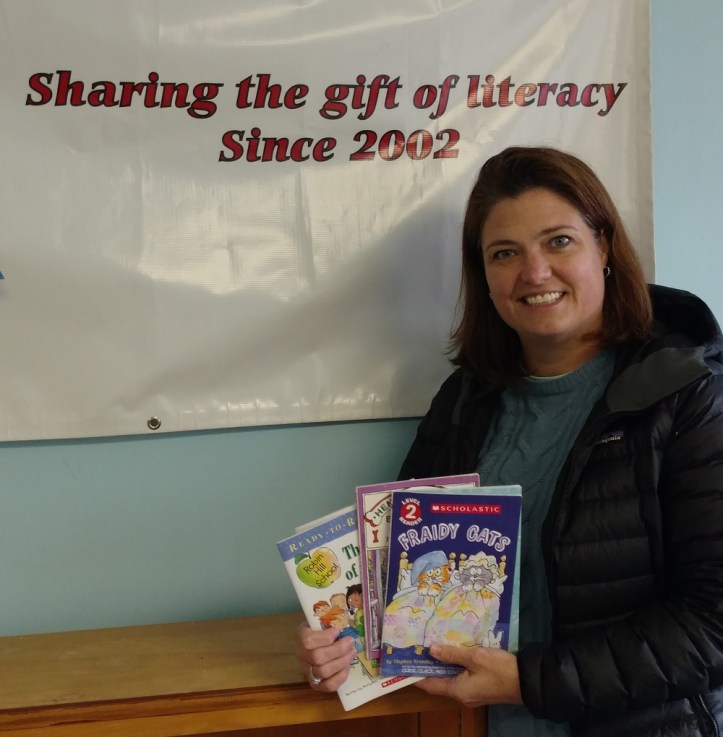 Cristen Zipf, founder of Treasures for Educators with just a few of the books recently donated by Success Won't Wait.